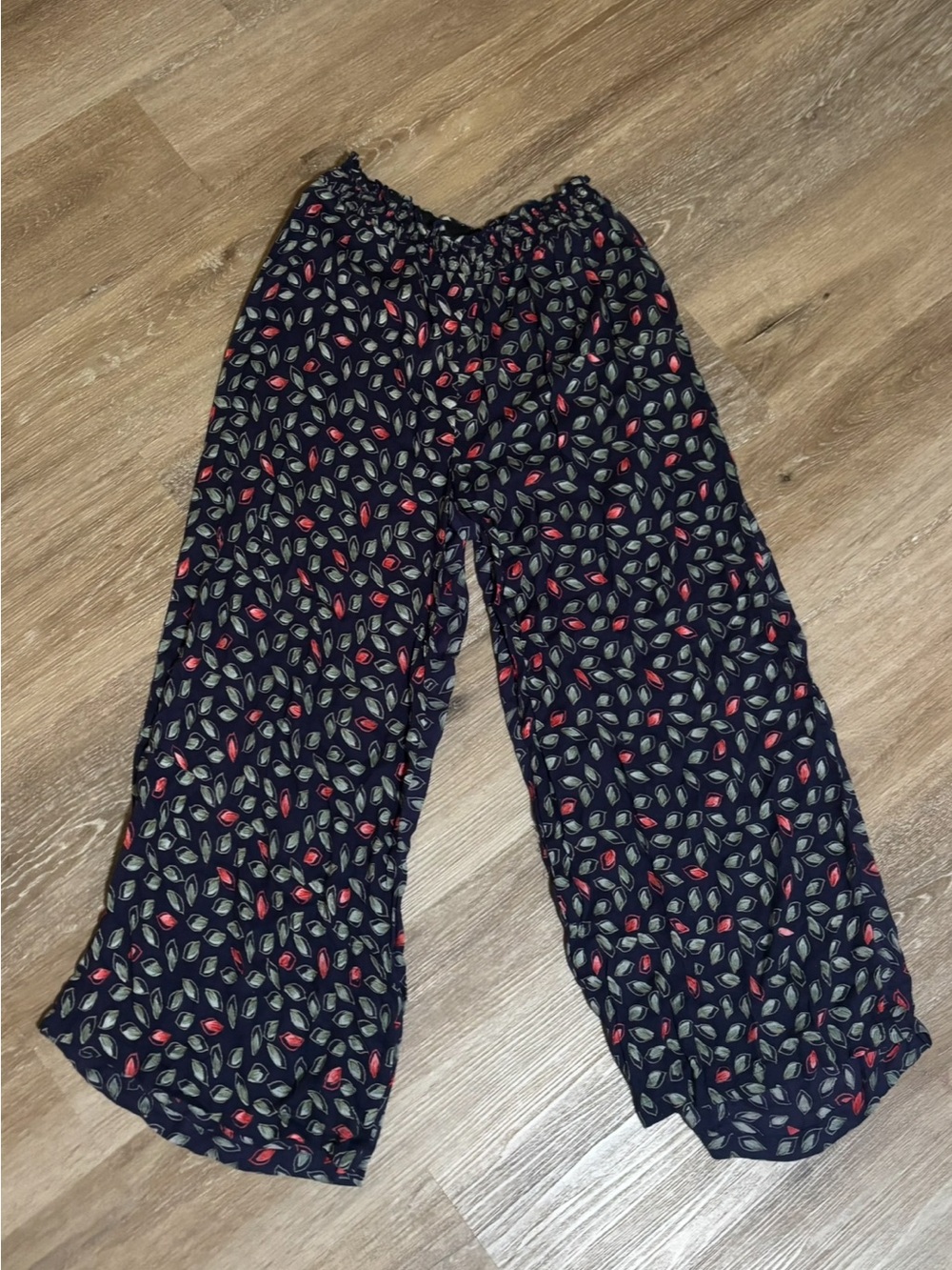 Angie womens navy wide leg, flowy pants. Green and red leaf-like design
